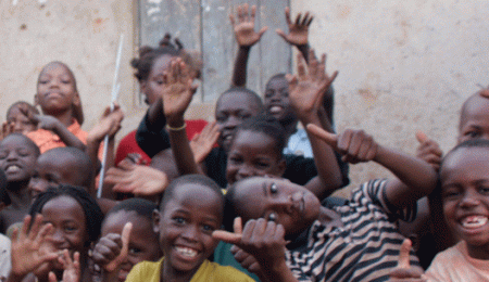 Happy children posing for the camera in Namuwongo slum