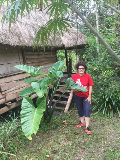 Home is a thatched wooden cottage on the edge of Kibale Forest