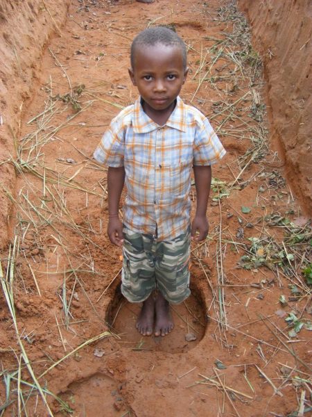 boy in elephant trench Ishasha Queen Elizabeth National Park