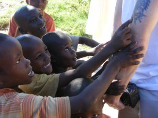 Kids admire muzungu's tattoos Kampala