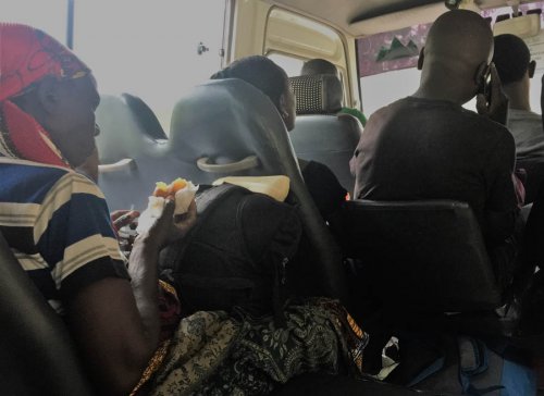 lady eating in bus. Nyirangarama Rwandan snack foods