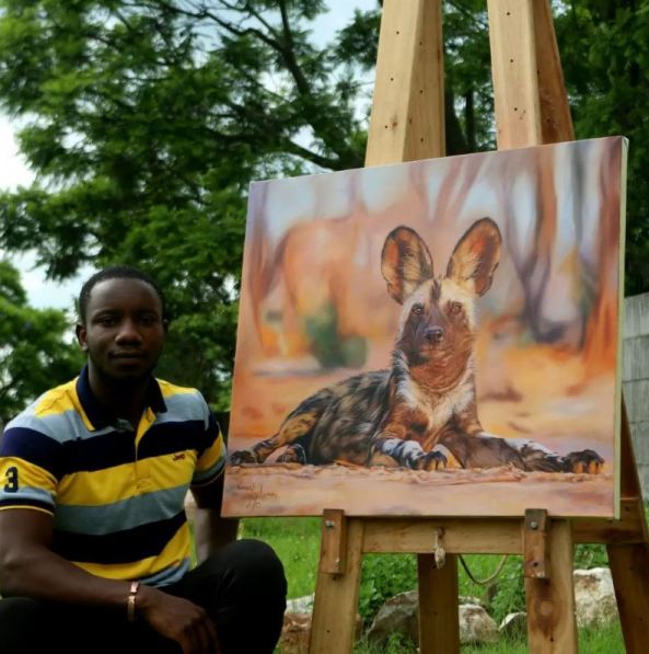 An African wild dog pictured with painter himself Carrel Kumbirai