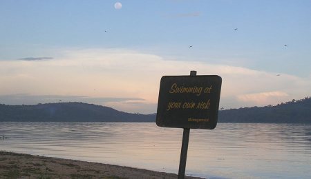 Signpost "swimming at your own risk", Munyonyo, Lake Victoria