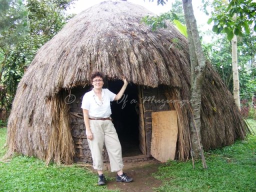 A very frumpy-looking Muzungu checking out the traditional accommodation option